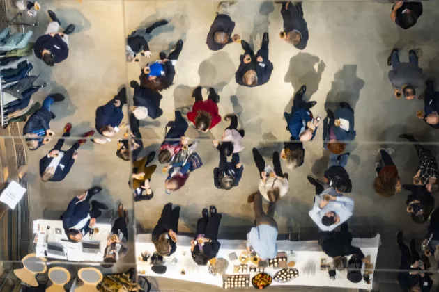 People mingle at a gathering. Photo from above. 